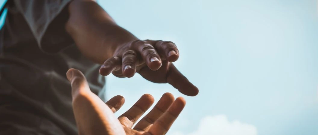 Hands of spouses reaching to each other symbolizing their eagerness to fix their miscommunication