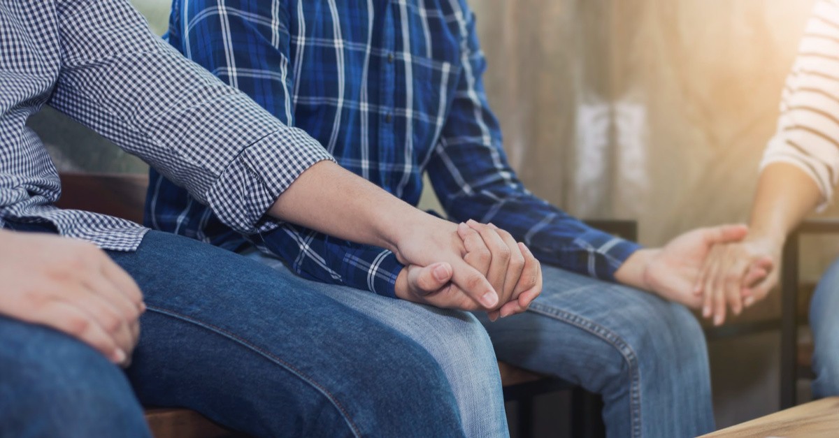 People holding hands in prayer
